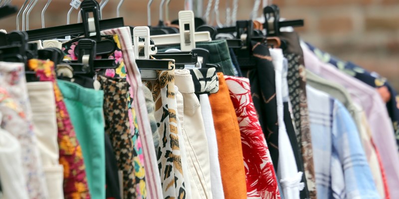 vintage clothes hanging in the flea market of used things